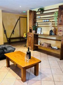 a room with a table with a bottle of wine on it at Chalet Les Lanchettes in Morzine