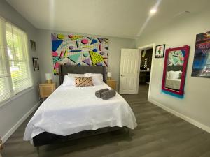 a bedroom with a bed and a colorful wall at Totally 80s! in Sanford
