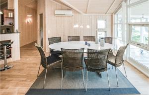a dining room with a white table and chairs at Awesome Home In Sydals With Sauna in Skovbyballe