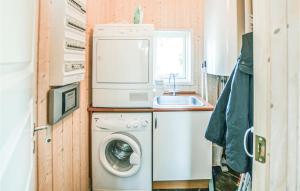 a small kitchen with a washing machine and a sink at Awesome Home In Sydals With Sauna in Skovbyballe