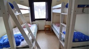 a room with two bunk beds and a window at STF Abisko Turiststation in Abisko