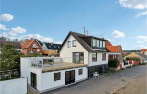 an exterior view of a white house with a balcony at Beautiful Home In Allinge With 3 Bedrooms in Allinge