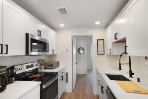a kitchen with white cabinets and a stove at Watch the Sunrise on Lake Louisa in Clermont