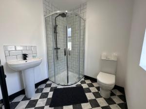 a bathroom with a shower and a toilet and a sink at OYO The Avenue in Scunthorpe
