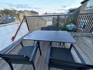 a blue table and two chairs on a deck at Super 1 bedroom in a stunning apartment with shared kitchen and living room - 2C The Charteris in London