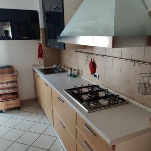 a kitchen with a stove and a counter top at Elegante appartamento trilocale in Milan