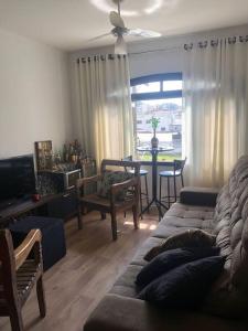 Et opholdsområde på Espaço acolhedor, no Guarujá