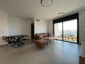 a living room with a couch and a table at Menahem Arber 4 Bedroom in Tel Aviv