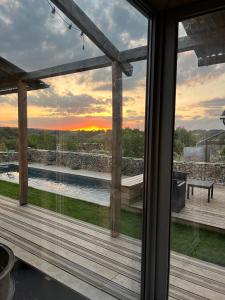 a view out the window of a house with a pool at L'Alrance del traouc in Bozouls
