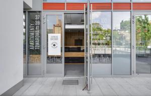 an open door of a building with a sign on it at Poznań Apartments Towarowa in Poznań