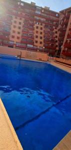 una gran piscina azul frente a un edificio en Apartamento jardin del mar 7.5, en La Manga del Mar Menor