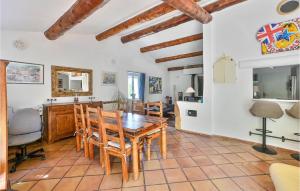 a kitchen and dining room with a table and chairs at Nice Home In Maubec With 3 Bedrooms, Private Swimming Pool And Outdoor Swimming Pool in Maubec
