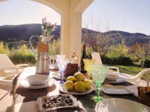 a table with plates of food and a bottle of wine at locations-06 La Pascaline in Le Bar-sur-Loup