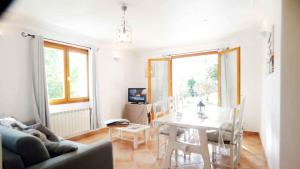 a living room with a table and a dining room at locations-06 La Pascaline in Le Bar-sur-Loup