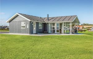a gray house with a large grass yard at Three-Bedroom Holiday Home In Nordborg in Nordborg +20 photos