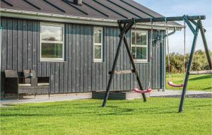 a swing in a yard in front of a house at Three-Bedroom Holiday Home In Nordborg in Nordborg