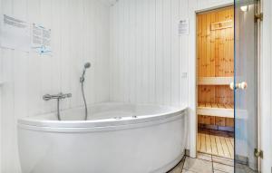 a white bath tub in a bathroom with a shower at Three-Bedroom Holiday Home In Nordborg in Nordborg