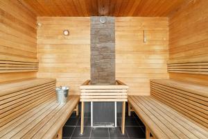 a sauna with two benches and a fireplace in it at Best Western Plus Sthlm Bromma in Stockholm