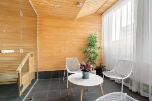a room with a table and chairs and a wooden wall at Best Western Plus Sthlm Bromma in Stockholm