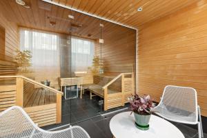 a room with a sauna with a table and chairs at Best Western Plus Sthlm Bromma in Stockholm