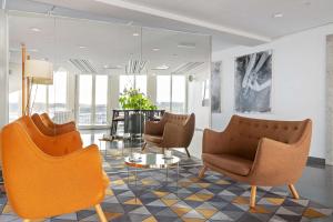a lobby with two chairs and a table at Best Western Plus Sthlm Bromma in Stockholm