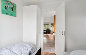 a bedroom with a bed and a door leading to a living room at Gorgeous Home In Sams With Kitchen in Kolby Kås