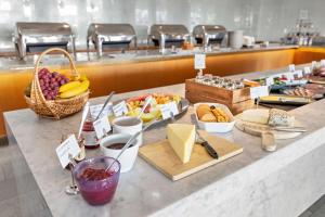 a buffet with a bunch of food on a counter at Best Western Plus Sthlm Bromma in Stockholm
