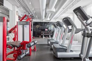 a gym with rows of treadmills and machines at Best Western Plus Sthlm Bromma in Stockholm
