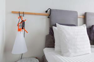 a bedroom with a bed and a white pillow at Best Western Plus Sthlm Bromma in Stockholm