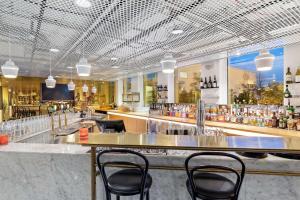 a bar in a restaurant with chairs and a counter at Best Western Plus Sthlm Bromma in Stockholm