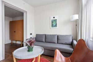 a living room with a couch and a table at Best Western Plus Sthlm Bromma in Stockholm