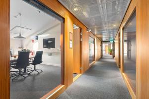 an office corridor with chairs and a table in the distance at Best Western Plus Sthlm Bromma in Stockholm