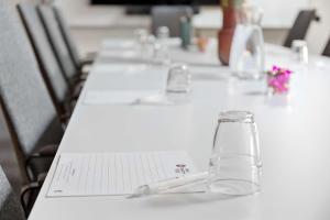 a row of tables with wine glasses on them at Best Western Plus Sthlm Bromma in Stockholm