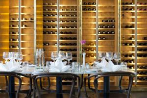 a table with chairs and wine glasses in a wine cellar at Best Western Plus Sthlm Bromma in Stockholm