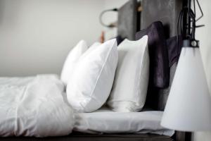 a pile of pillows sitting on a bed at Best Western Plus Sthlm Bromma in Stockholm