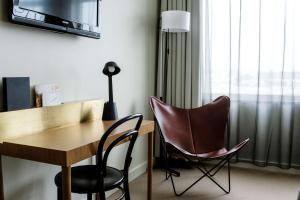 a room with a desk and two chairs and a lamp at Best Western Plus Sthlm Bromma in Stockholm
