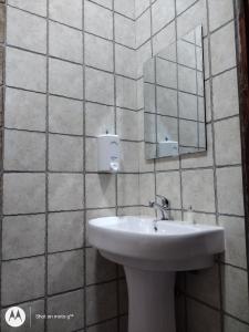 a bathroom with a sink and a mirror at Luxury Villa Garden in Dar es Salaam