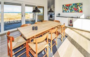 ロッケンにあるCozy Home In Lkken With Kitchenのキッチン、ダイニングルーム(木製のテーブルと椅子付)