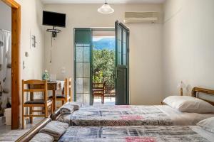 a bedroom with a bed and a desk and a table at Daratos studio 5 in Kefallonia
