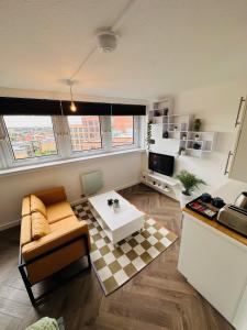 a living room with a couch and a table at Private Room in Modern Shared Apartment, Each with Kitchenette, Central Birmingham in Birmingham