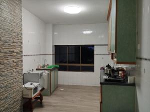 a small kitchen with a counter and a window at Klebang Condominium Melaka in Malacca