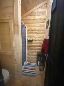 a small bathroom with a toilet in a log cabin at Cozy Log Tiny Cabin in Red River Gorge! in Campton