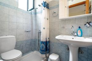 a bathroom with a toilet and a sink at Daratos apartment 6 in Kefallonia