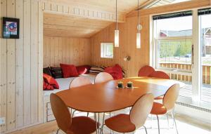 a room with a table and chairs and a couch at Awesome Home In Brkop With 3 Bedrooms, Sauna And Wifi in Brejning