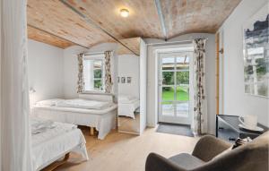 a bedroom with two beds and a window at Amazing Apartment In Ringkbing With Wifi in Ringkøbing