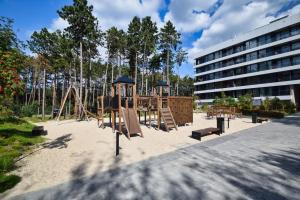 a playground in front of a building at RentPlanet - Apartamenty Shellter in Rogowo
