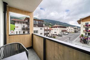 a balcony with a bench and a view of a street at Ferienwohnung Lamm 2 in San Valentino alla Muta