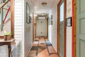 a hallway in a house with white walls and a tile floor at Charming holiday home in Kungsgarden, Gastrikland in Kungsgården