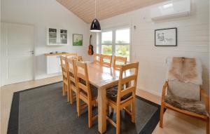 a dining room with a wooden table and chairs at Awesome Home In Sydals With 4 Bedrooms, Sauna And Wifi in Skovby