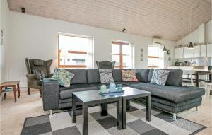 HelberskovにあるNice Home In Hadsund With 3 Bedrooms, Sauna And Wifiのリビングルーム(ソファ、テーブル付)